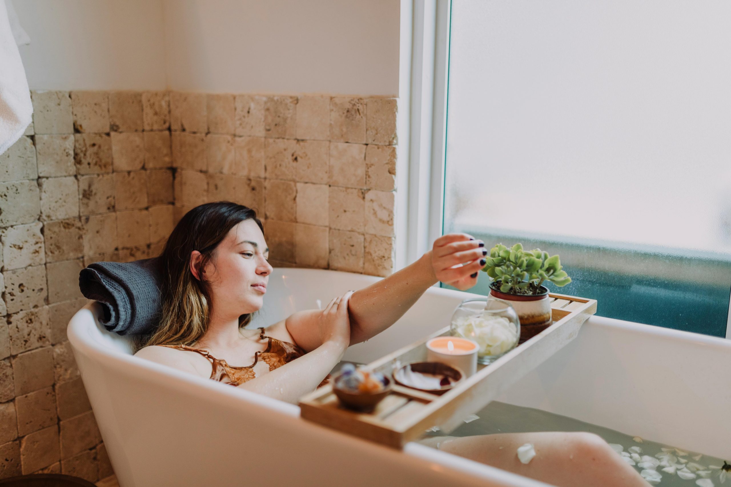 A woman with radiant, healthy skin relaxing in a wellness clinic